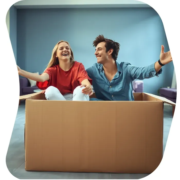 Two guys sitting on the floor of their apartment with Muval moving boxes